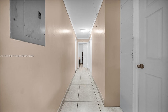 hallway featuring light tile patterned flooring, crown molding, and electric panel