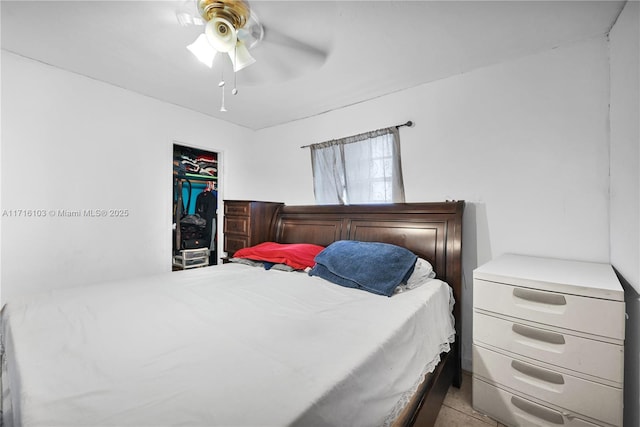 tiled bedroom featuring ceiling fan