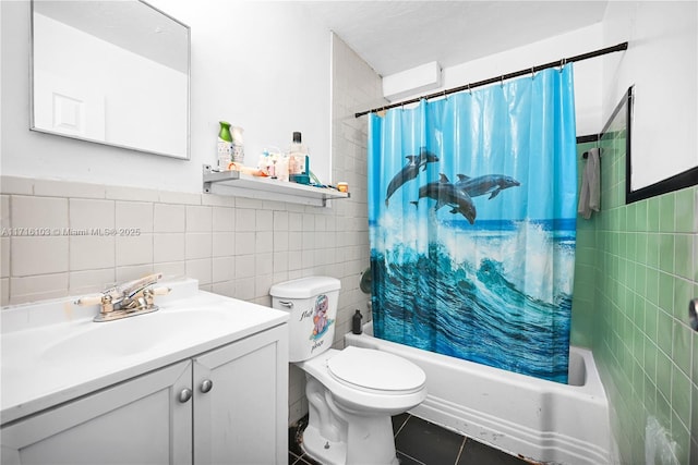 full bathroom featuring vanity, shower / bath combo with shower curtain, tile walls, tile patterned flooring, and toilet