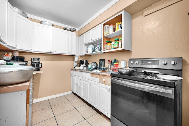 kitchen featuring stainless steel electric range, light tile patterned flooring, white cabinetry, and crown molding