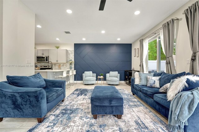 back of house featuring ceiling fan, a patio area, and a lawn