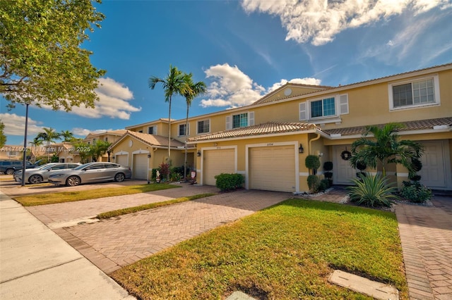 view of front of house with a garage and a front lawn