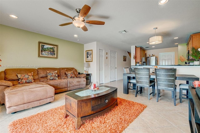 living room with light tile patterned floors and ceiling fan