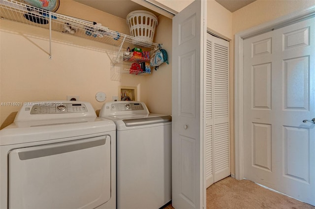 clothes washing area with light carpet and independent washer and dryer