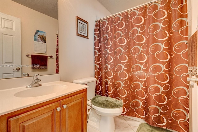 bathroom featuring tile patterned flooring, vanity, a textured ceiling, and toilet