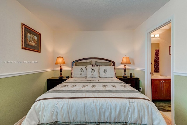 bedroom featuring sink and connected bathroom