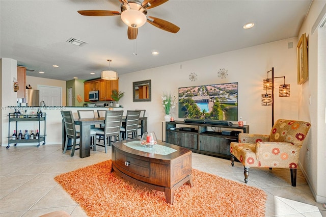 tiled living room with ceiling fan