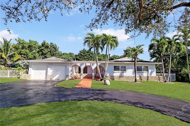 ranch-style home featuring a front yard and a garage