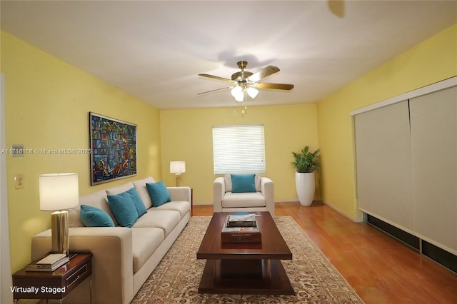 living room with light wood-type flooring and ceiling fan