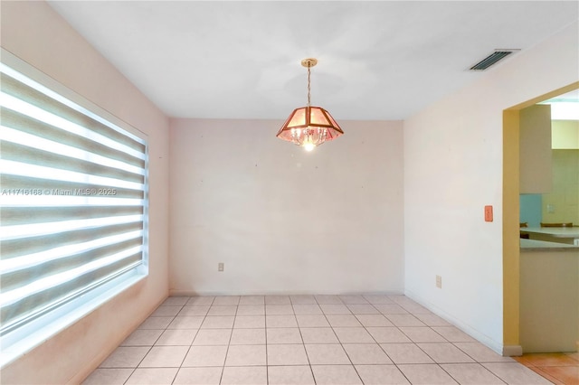 unfurnished room featuring light tile patterned floors