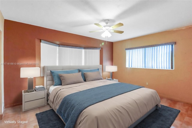 bedroom with ceiling fan and light tile patterned floors