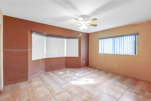 unfurnished room with ceiling fan and light tile patterned floors