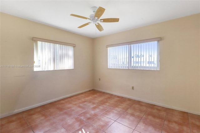 spare room featuring ceiling fan and light tile patterned flooring