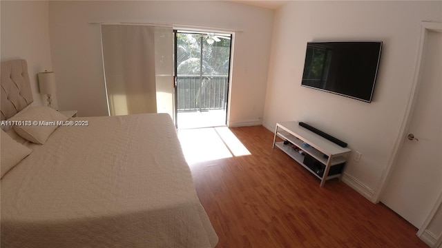 bedroom with access to exterior and wood-type flooring