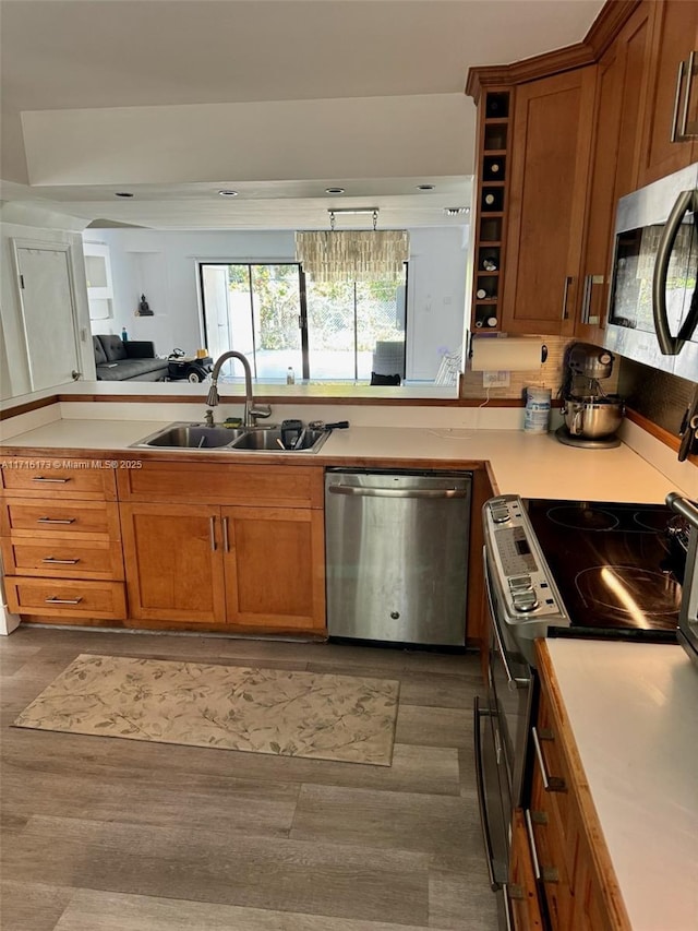 kitchen with stainless steel appliances, dark hardwood / wood-style floors, and sink