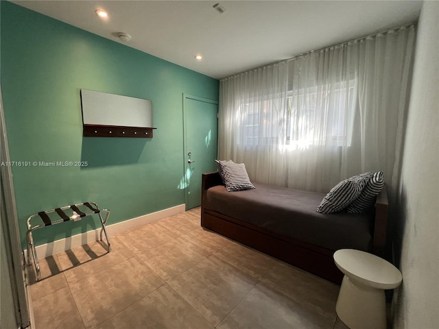 bedroom with tile patterned floors and baseboards