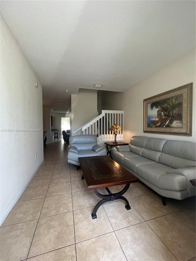 tiled living room with a textured ceiling