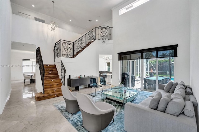 living room featuring a towering ceiling and an inviting chandelier