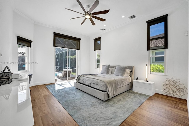 bedroom featuring access to exterior, hardwood / wood-style floors, ceiling fan, and crown molding