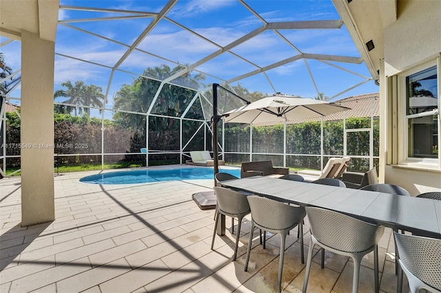 view of swimming pool featuring a patio and glass enclosure