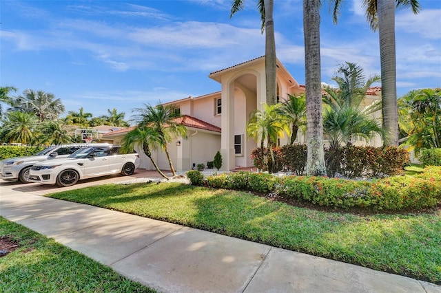 mediterranean / spanish house featuring a front lawn