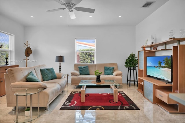 living room with ceiling fan and a wealth of natural light