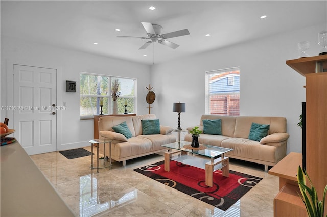 living room with plenty of natural light and ceiling fan