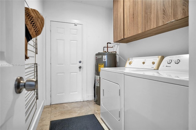 clothes washing area with cabinets, independent washer and dryer, and water heater