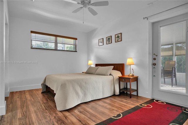 bedroom with hardwood / wood-style flooring, ceiling fan, and access to outside