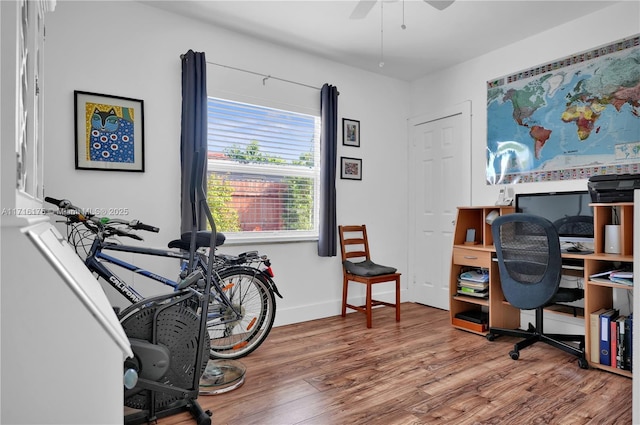 home office with hardwood / wood-style flooring and ceiling fan