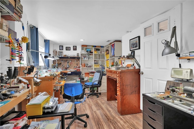 office area featuring a workshop area and light hardwood / wood-style floors