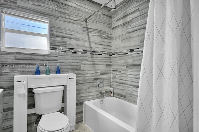 bathroom featuring toilet, shower / bathtub combination with curtain, and tile walls