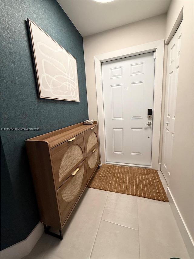 doorway with tile patterned floors