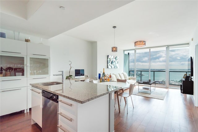 kitchen featuring dishwasher, white cabinetry, floor to ceiling windows, and hanging light fixtures