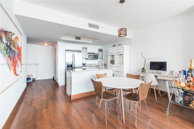 dining area with dark wood-type flooring