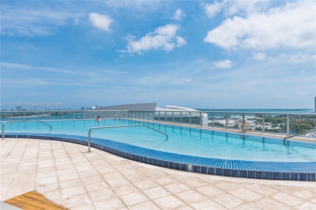 view of pool with a water view