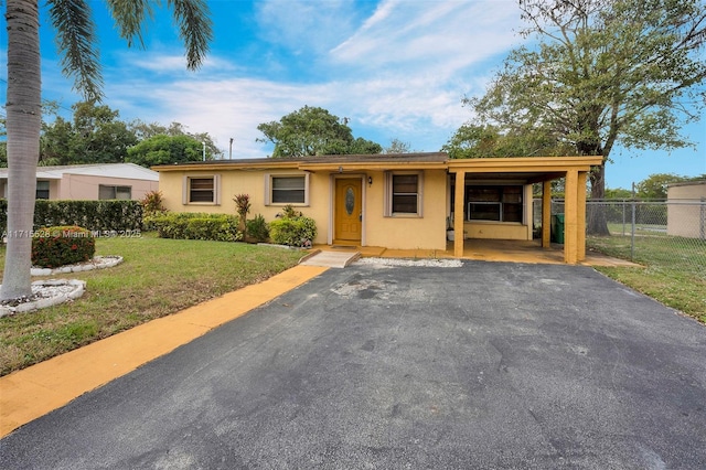 ranch-style house with a front lawn and a carport