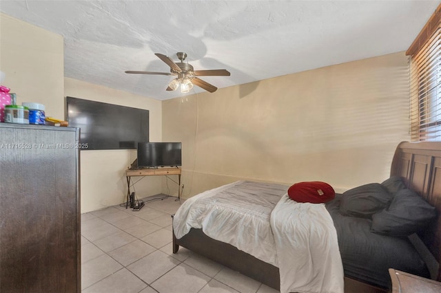 tiled bedroom with ceiling fan and a textured ceiling