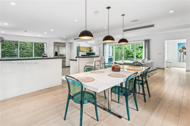 dining space featuring light wood-type flooring