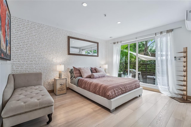 bedroom featuring brick wall and light wood-type flooring