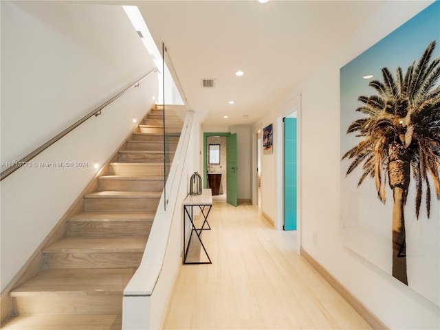 stairs featuring hardwood / wood-style floors