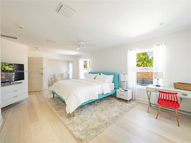 bedroom with ceiling fan and light hardwood / wood-style floors