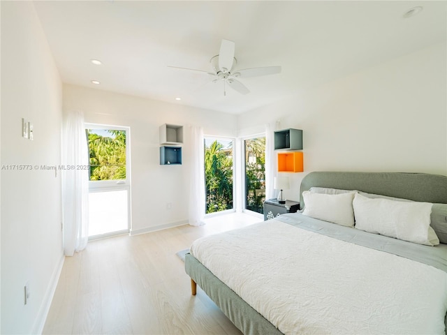 bedroom featuring ceiling fan and light hardwood / wood-style flooring