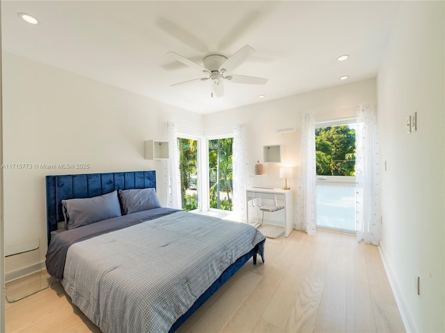 bedroom with ceiling fan and light hardwood / wood-style floors