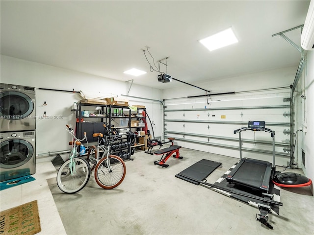 garage with a garage door opener and stacked washer and dryer