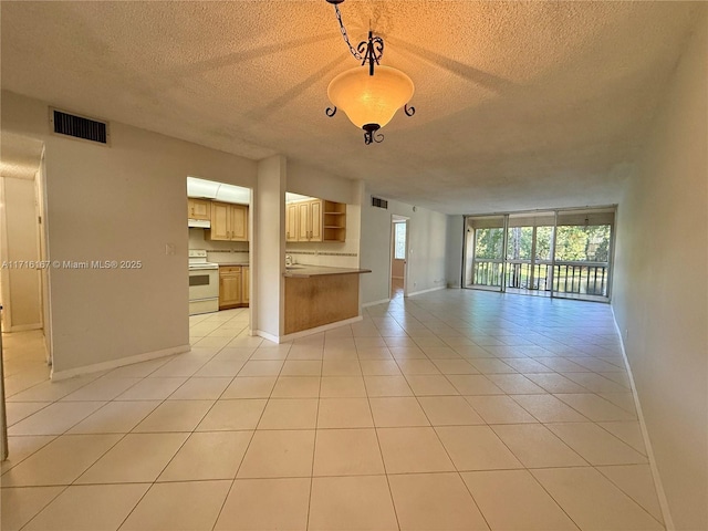 unfurnished living room featuring light tile patterned floors and a textured ceiling