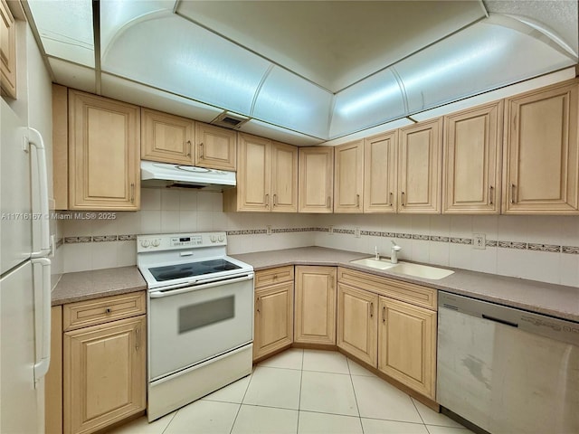 kitchen featuring white appliances, sink, decorative backsplash, light tile patterned floors, and light brown cabinetry