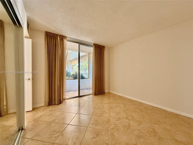 tiled spare room with a textured ceiling