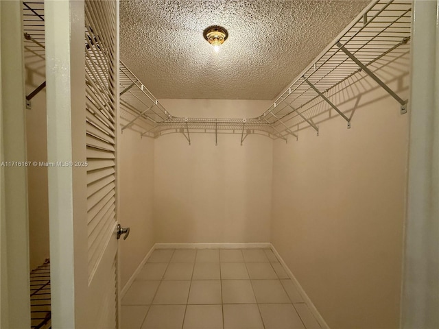 walk in closet with tile patterned floors