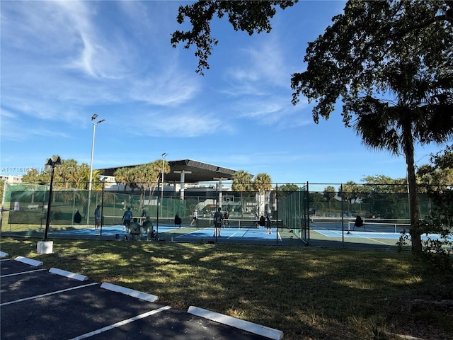 view of sport court with a lawn